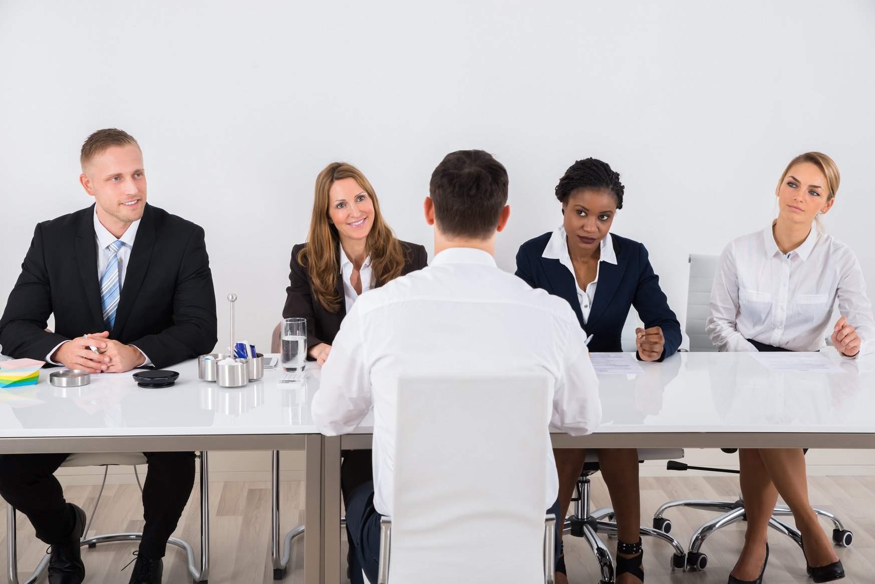 Businesspeople Interviewing Man